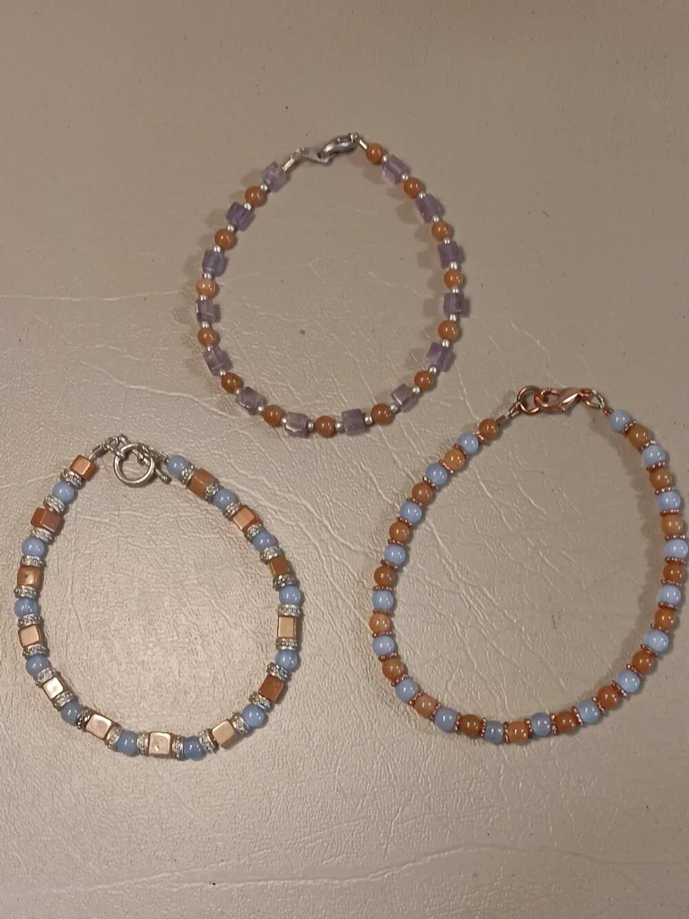 Lot of 3 stone bead bracelets pale blue light orange purple tones